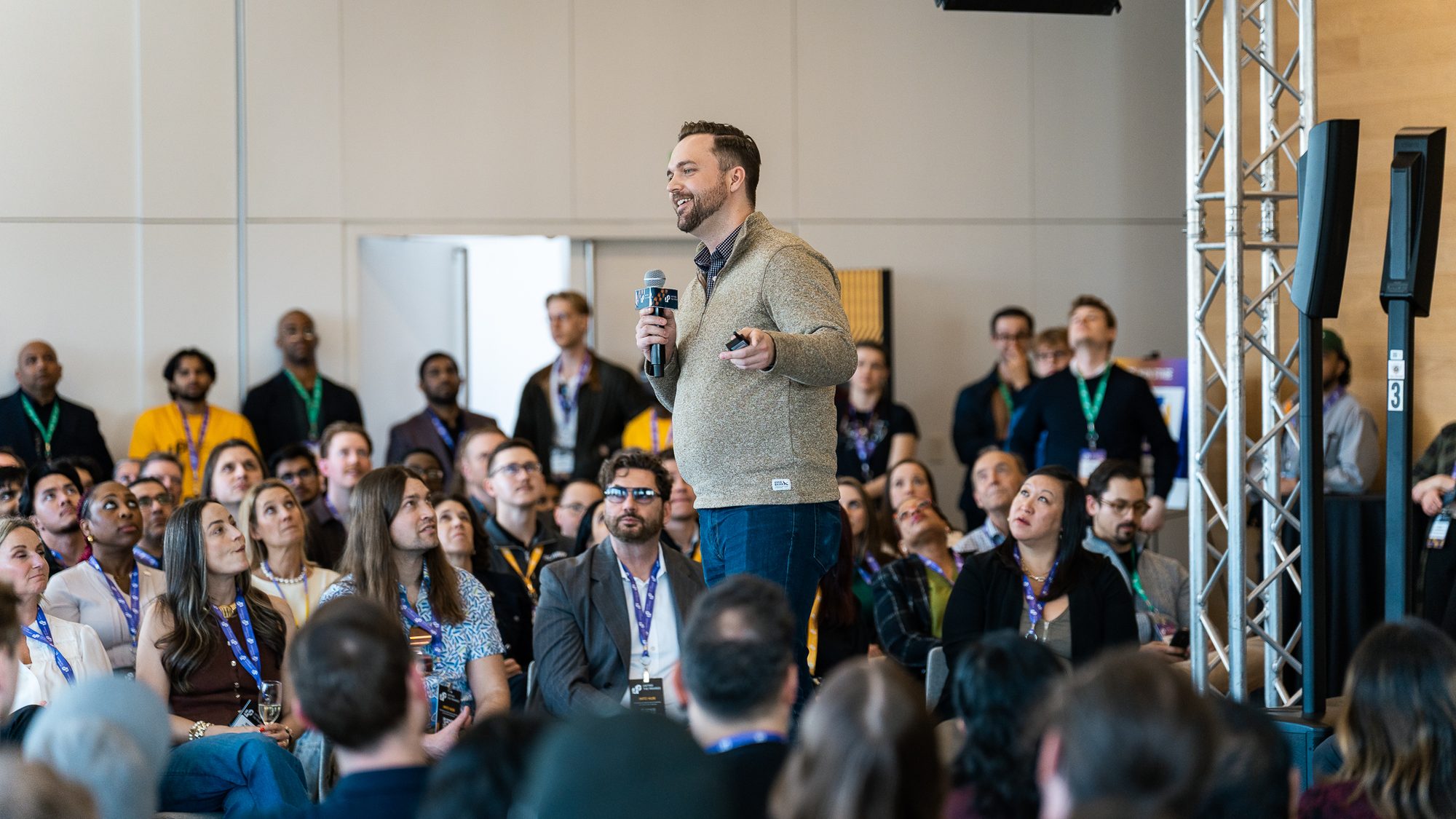 A speaker stands with a microphone amid a seated audience at a Co.Labs event, Saskatoon.