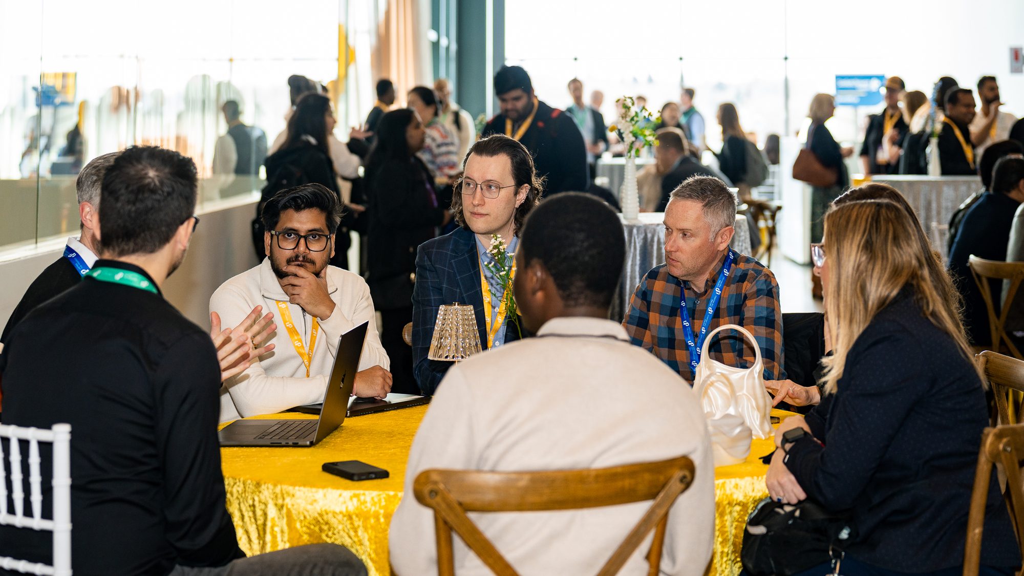 A roundtable discussion at a yellow-clothed table at a Co.Labs conference, Saskatoon.